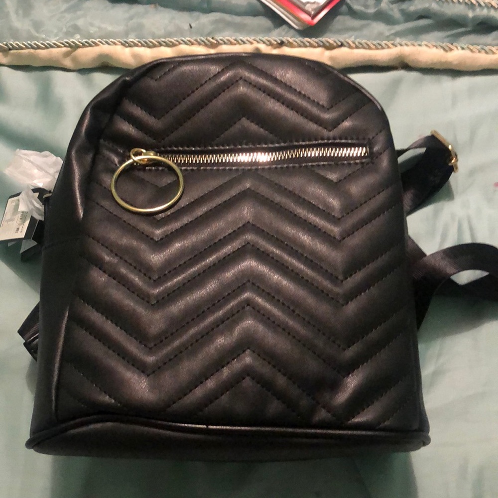 Cute small black and gold backpack